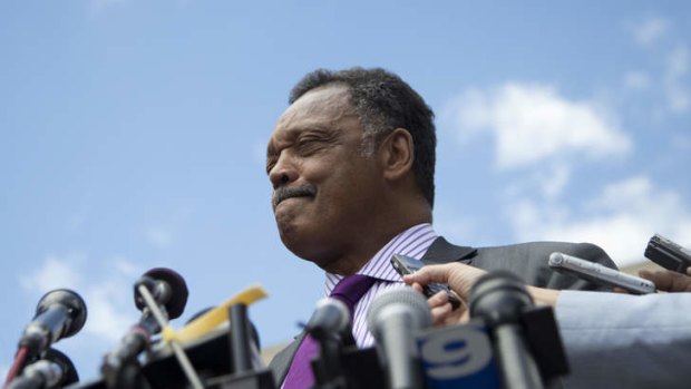 Reverend Jesse Jackson pauses as he he speaks to media outside federal court in Washington after his son was sentenced to two and a half years in prison.