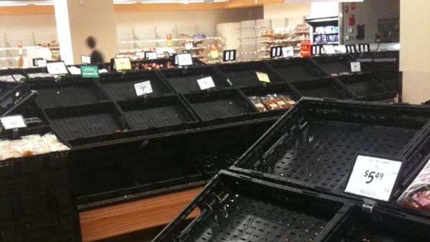 Empty shelves at Coles, Woolloongabba where shoppers have snapped up staple foods such as meat, fresh fruit and bread.