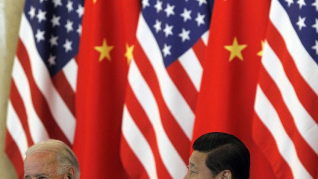 Getting to know you ... US vice president Joe Biden (L) speaks as Chinese vice president Xi Jinping looks on.