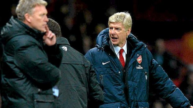 Tight race: Arsenal manager Arsene Wenger reacts at Old Trafford as Manchester United manager David Moyes looks on.
