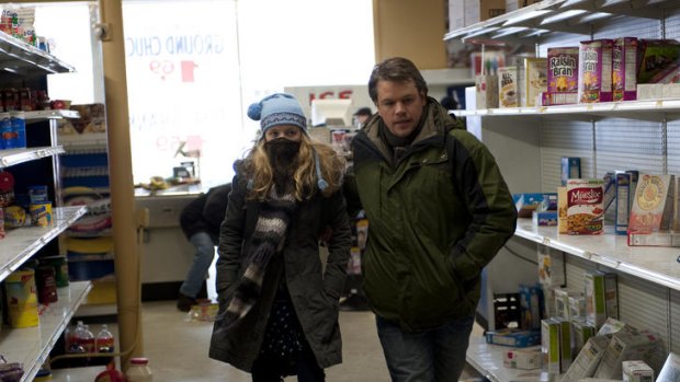 In search of a story: A worried dad (Matt Damon) leads his kid through the dull shambles of <i>Contagion</i>.