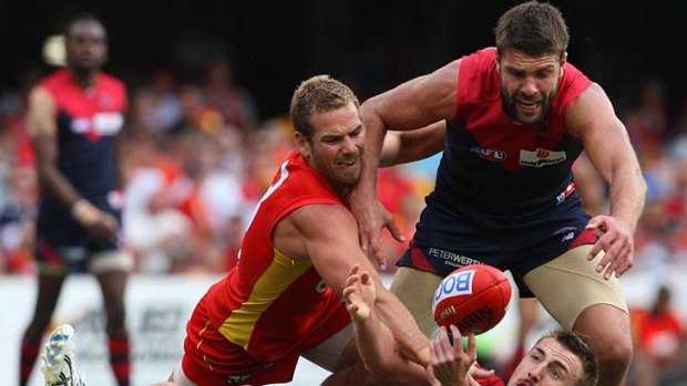 Smash and grab: Melbourne's Lynden Dunn tries to get his hands on the ball.