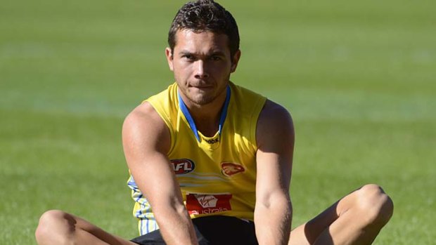 Breather: Jarrod Harbrow takes a break during training with Gold Coast yesterday.
