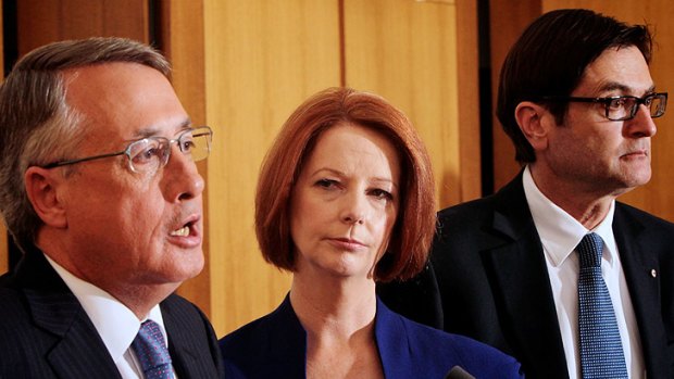 Julia Gillard (centre), with Deputy Prime Minister Wayne Swan (left) and Climate Change Minister Greg Combet, has revealed the details of her carbon tax scheme.