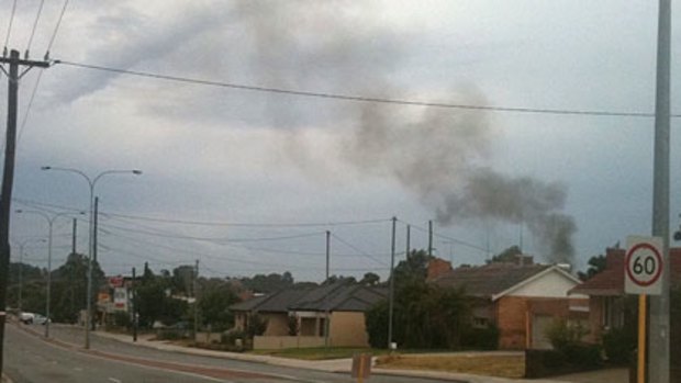 Smoke rises into the air after the Yokine power substation was struck by lightning.