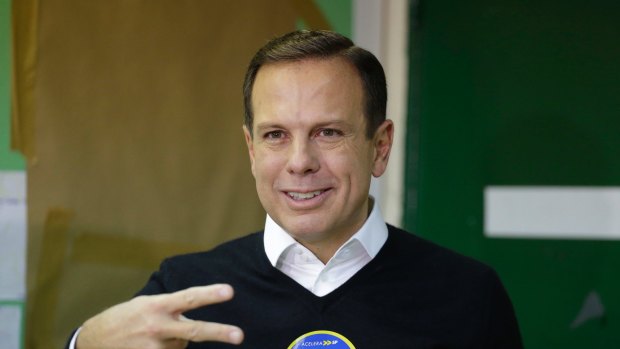 Joao Doria, mayoral candidate with the Brazilian Social Democracy Party gestures after voting in the municipal election in Sao Paulo, Brazil, Sunday, Oct. 2, 2016. For the first time since a bruising impeachment fight led to the ouster of President Dilma Rousseff, Brazilians vote in municipal elections that take place in more than 5,500 cities. (AP Photo/Nelson Antoine)