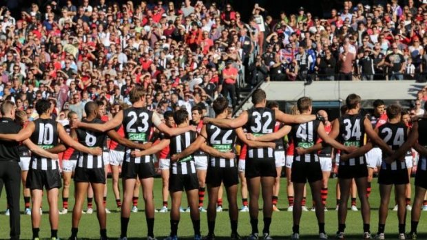 Essendon and Collingwood line up before the Anzac Day game in April this year.