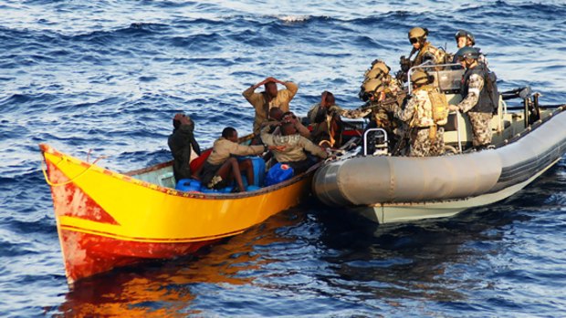 A boarding party searches the pirate boat.