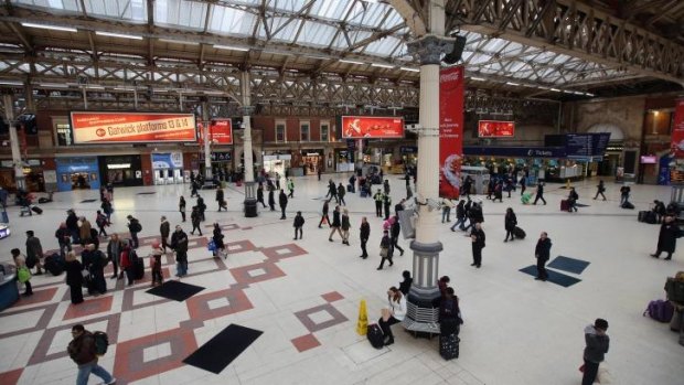 Passengers wait for trains in Victoria Station as severe weather has caused delays and cancellations to numerous UK rail services.
