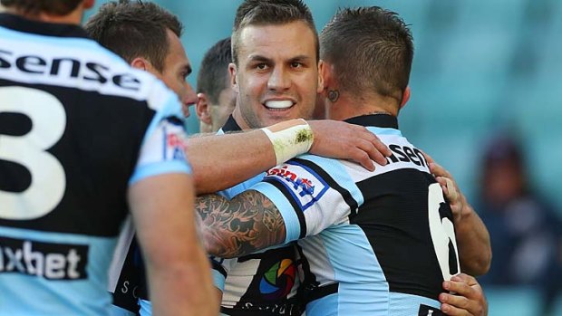 Beau Ryan of the Sharks celebrates after scoring his seventh-tackle try against North Queensland on Saturday.
