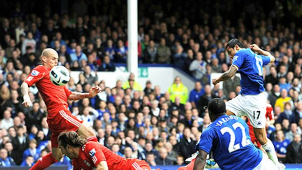 Tim Cahill (right) scores the opening goal for Everton during the clash with Liverpool at Goodison Park.
