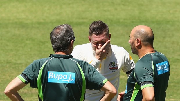 Michael Clarke shows his anguish after hurting his back while batting. 