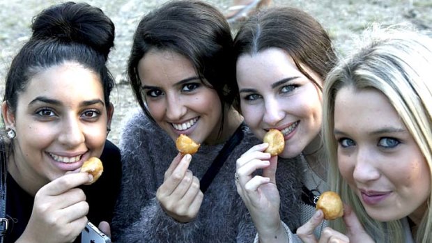Katerina Charalanbous, 16, Nina Kamitsis, 16, Katherine Ware, 16, and Lydia Giugni, 16,tuck into honey puffs at the festival.