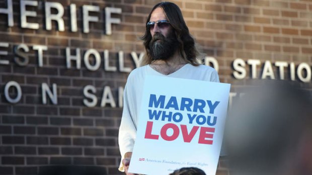 Support: A man dressed as Jesus at a rally in Hollywood.
