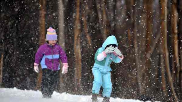 Fleur and Amelie Harper enjoy the snow at Lake Mountain.