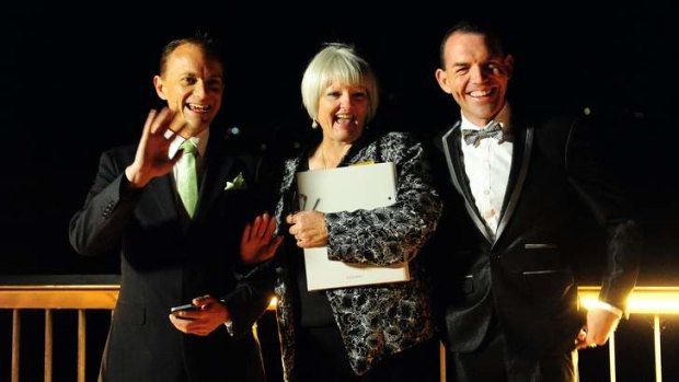 ACT celebrant Sharyn Gunn, centre, officiates over Australia's first Australian legal same sex marriage between Alan Wright  (left) and Joel Player.