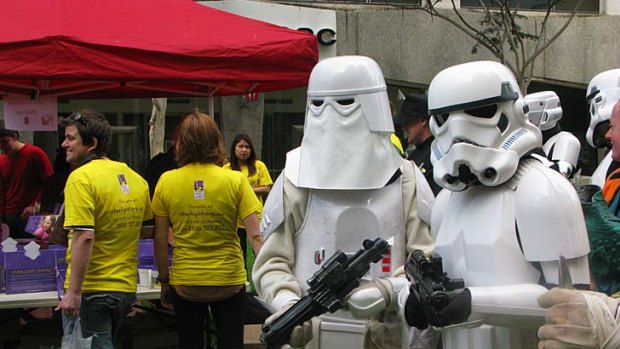 Star Wars fans dressed as Stormtroopers patrol Brisbane's CBD.