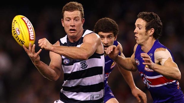 Steve Johnson of the Cats handballs during the round nine AFL match between the Western Bulldogs and the Geelong Cats at Etihad Stadium.