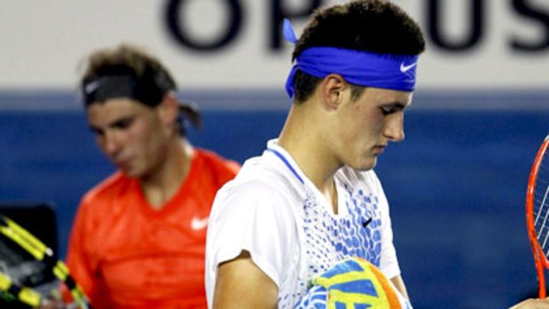 Bernard Tomic and Rafael Nadal change ends during the third round of the 2011 Australian Open.