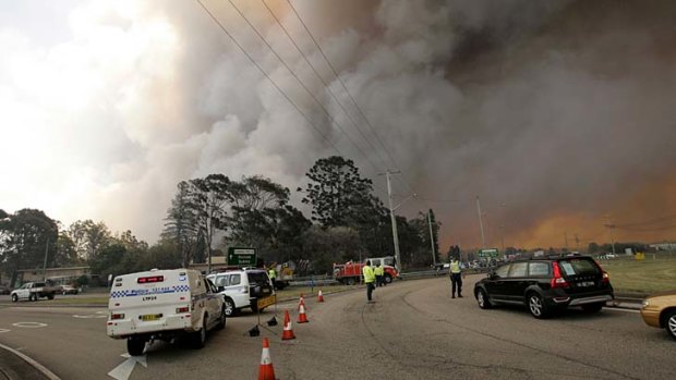 Bushfires close in: A fire breaks containment lines at Williamtown on Thursday.