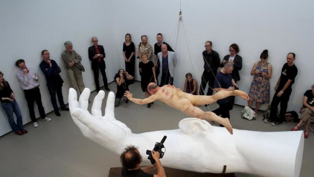 Stelarc floats, watched by critic Robert Nelson (second from left).