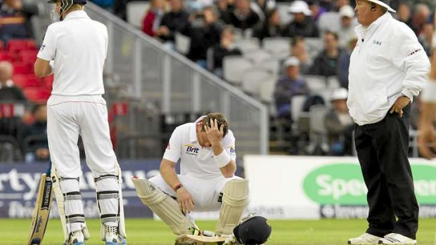 Ian Bell seeks attention after being struck on the thumb by Peter Siddle.