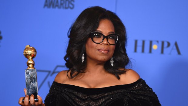 Oprah Winfrey poses in the press room with the Cecil B. DeMille Award at the 75th annual Golden Globe Awards.