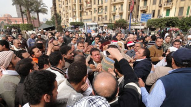 Mob rule ... a man suspected of being a policeman is mobbed in Tahrir Square.