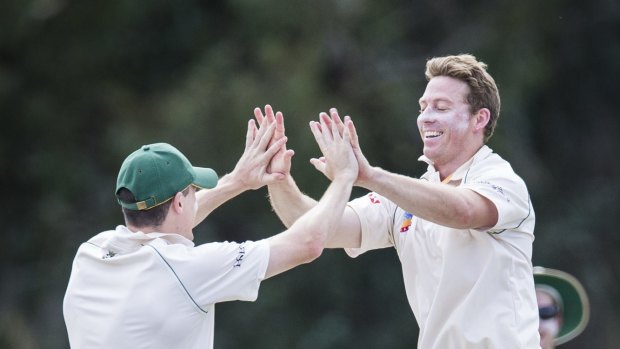 Adam Heading celebrates a wicket in Weston Creek Molonglo's clash with and ANU at Stirling Oval.
