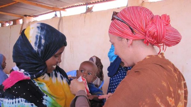 Helping hand: Hilary Floate tends to an outpatient at a feeding centre run by the Somali Red Crescent in Abudwaq, Somalia. PICTURE: RED CROSS