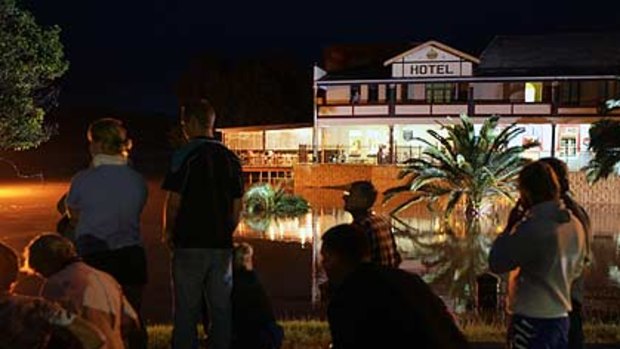 Local entertainment ... residents watch the Clarence River rise in Grafton.