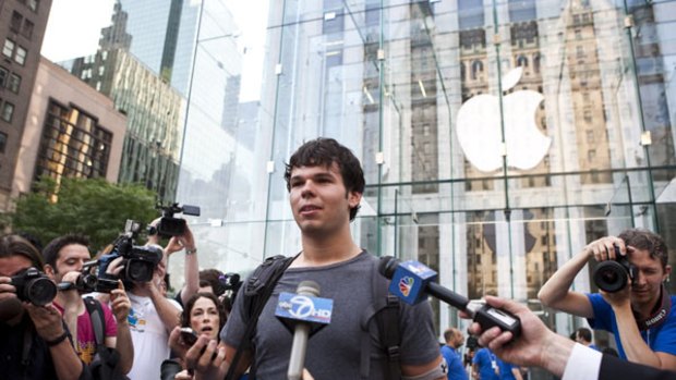 Evan Wiendczak mobbed by the media after buying the first iPhone 4 at the Apple store on Fifth Avenue in New York.