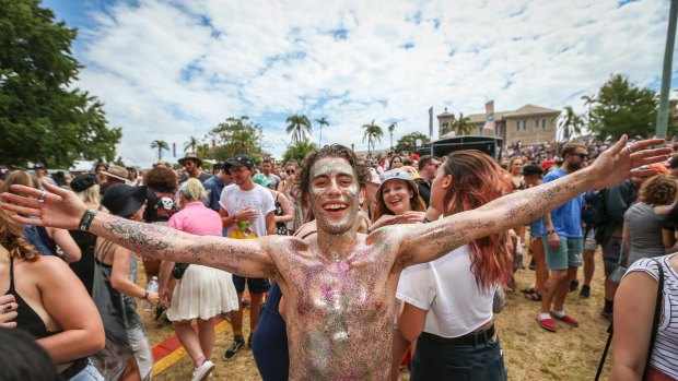 Music fans, including 'glitter guy'  Martyn Bechara shrug off the heat at St Jerome's Laneway Festival in Sydney.