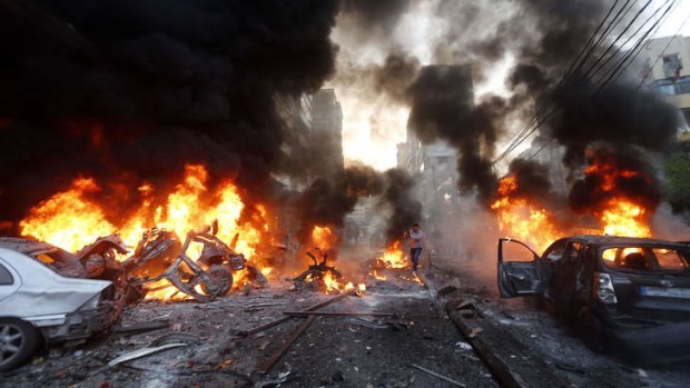 Flames rise from burning cars at the site of a car bomb explosion in south Beirut.