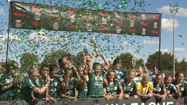 Canberra United players celebrate their 2011-12 W-League title.