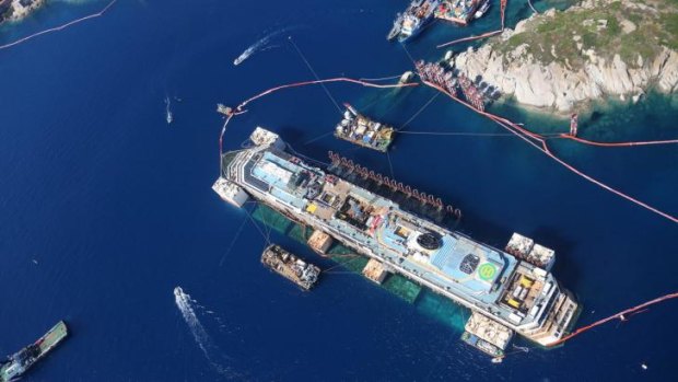 The Costa Concordia shipwreck during the operations to refloat it off the coastline of the tiny Tuscan island of  Giglio, Italy.