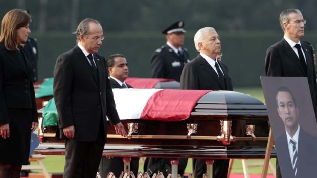 Tribute: Mexican President Felipe Calderon and his wife Margarita Zavala pay their respects at the funeral of Interior Minister Francisco Blake Mora in Mexico City.