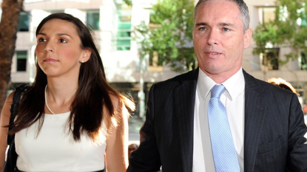 Craig Thomson, accompanied by his wife, arrives to face court in Melbourne.
