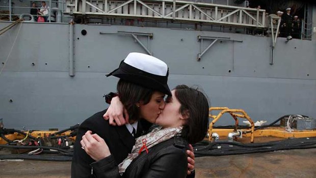 Petty Officer 2nd Class Marissa Gaeta, left, kisses her girlfriend of two years, Petty Officer 3rd Class Citlalic Snell at Joint Expeditionary Base Little Creek in Virginia Beach.