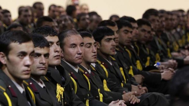Stepping up: Afghan defence officers attend a security handover ceremony at a military academy outside Kabul on Tuesday.