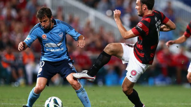 Derby time: Mark Bridge of the Wanderers is tackled by Alessandro Del Piero of Sydney FC.