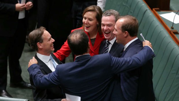 Environment Minister Greg Hunt (left) is congratulated by colleagues including Christopher Pyne and Kelly O'Dwyer.