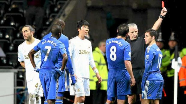 Eden Hazard of Chelsea (R) is sent off by referee Chris Foy.