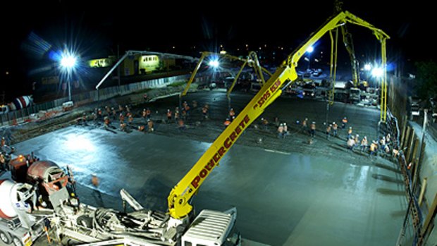 The perfect pour ... workers toil overnight on a section of the Airport Link.