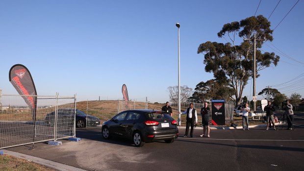 Bombers staff and security monitor cars at the club's Tullamarine base.
