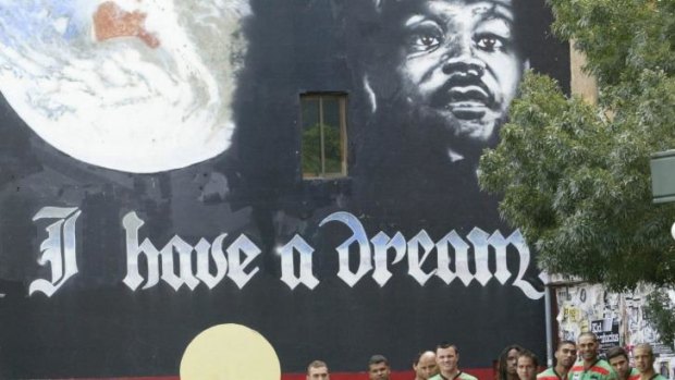 Band of brothers: Souths' indigenous contingent, led by David Peachey, third from right, in front of the inspirational mural in Newtown in 2007.