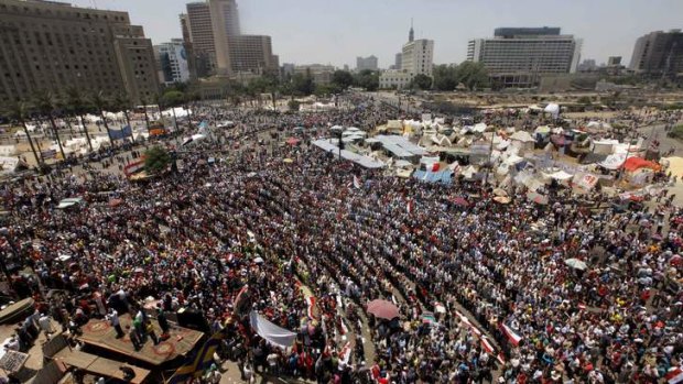 Bracing for trouble: Opponents of Egypt's Islamist President Mohammed Mursi gather for in Tahrir Square on Sunday.
