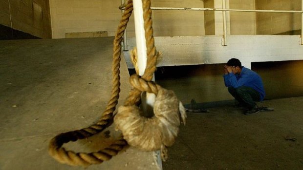 Long history of capital punishment ... A hanging noose rests on a rail as a Iraqi teenager inspects the gallows in the execution room of the infamous Abu Ghraib prison in Baghdad, Iraq.