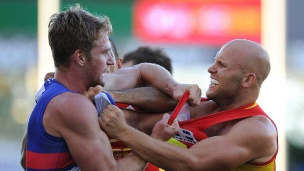 Gary Ablett of the Suns and Jake Stringer of the Bulldogs wrestle during the round 10 AFL match between the Gold Coast Suns and the Western Bulldogs.