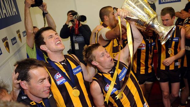 Hawthorn's Stephen Gilham celebrates with Alastair Clarkson and Sam Mitchell after defeating Geelong in the 2008 Grand Final.